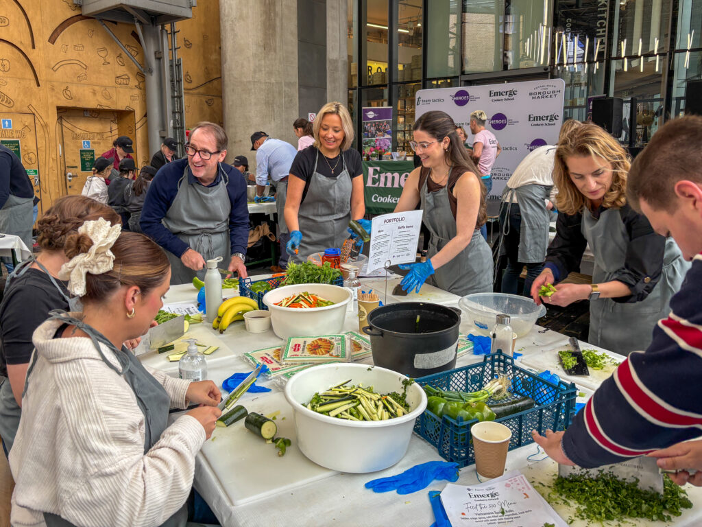 Portfolio team members cooking at feed the 500 event